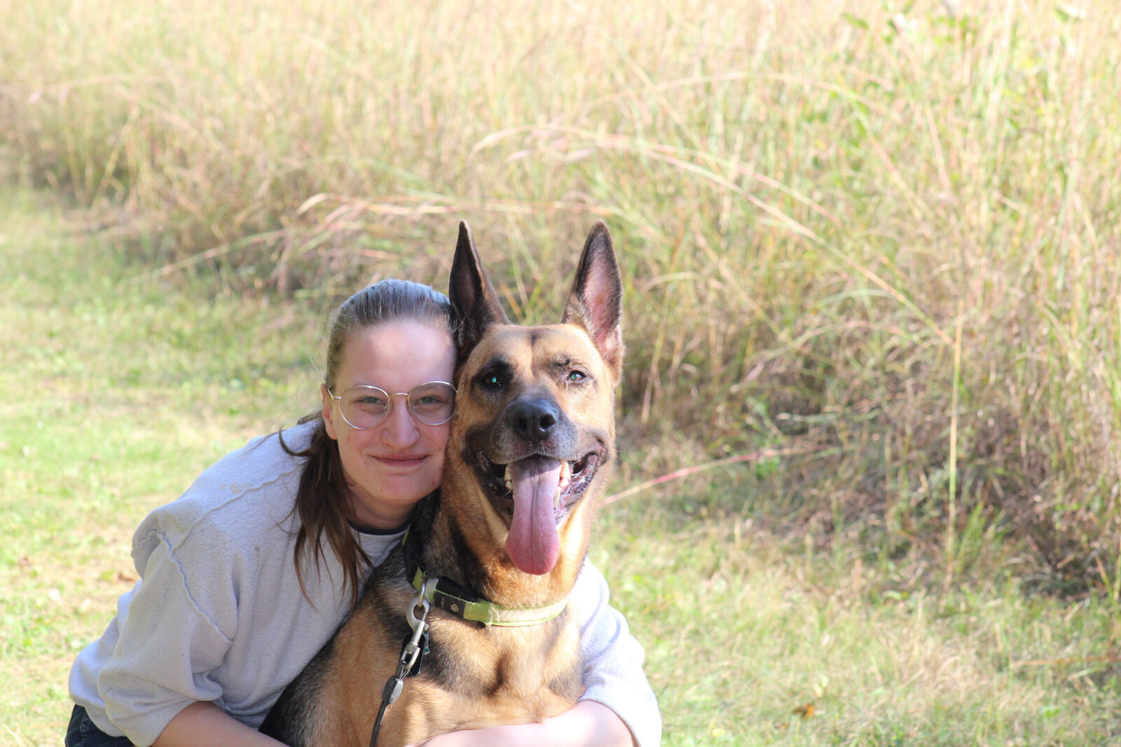 Kyrsten with Woden, their dog, outdoors